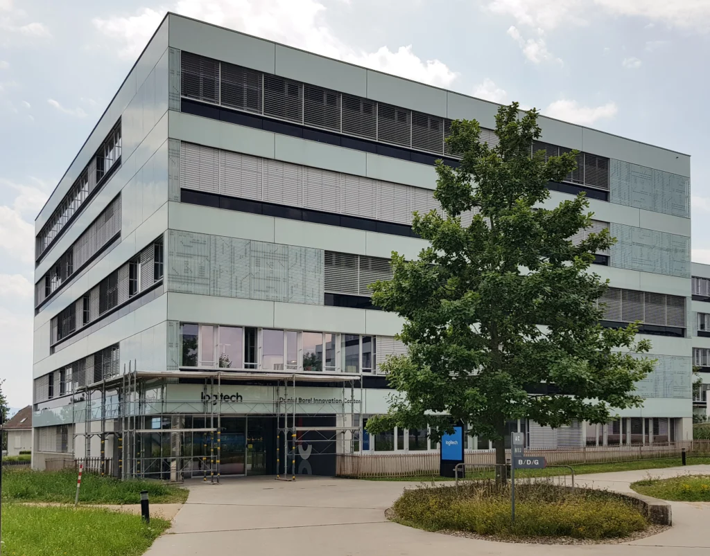 Logitech corporate office building exterior with modern glass facade and tree