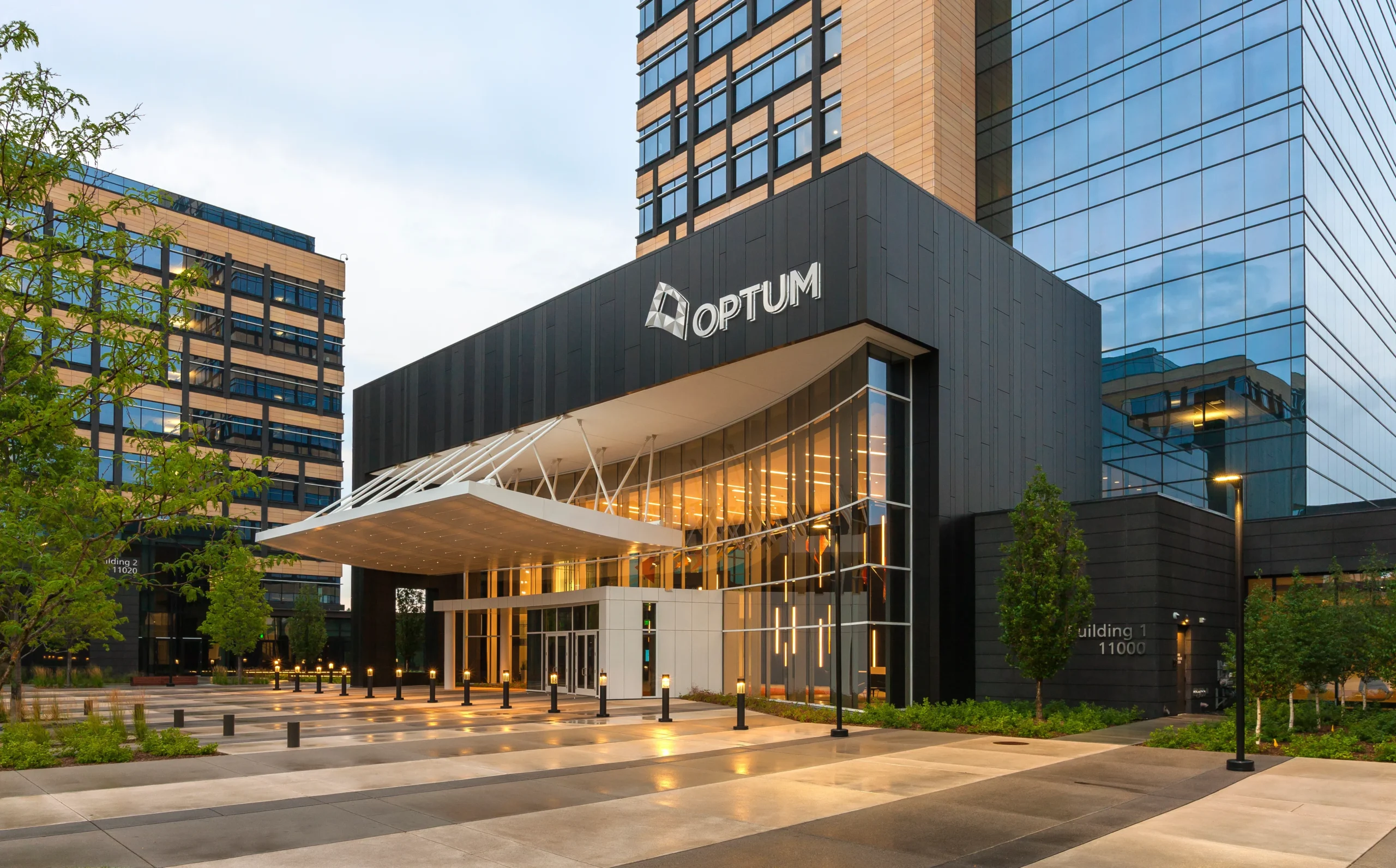 Optum office building entrance with modern glass façade and illuminated lobby