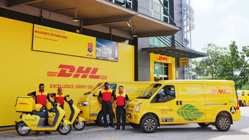 DHL delivery staff standing with electric scooters and delivery vans