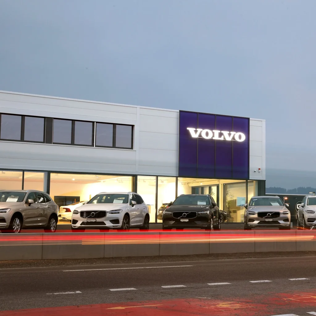 Volvo showroom building featuring the Volvo logo and parked Volvo cars, representing Volvo careers and job opportunities.